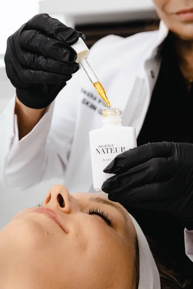 Professional serum application during an advanced facial treatment